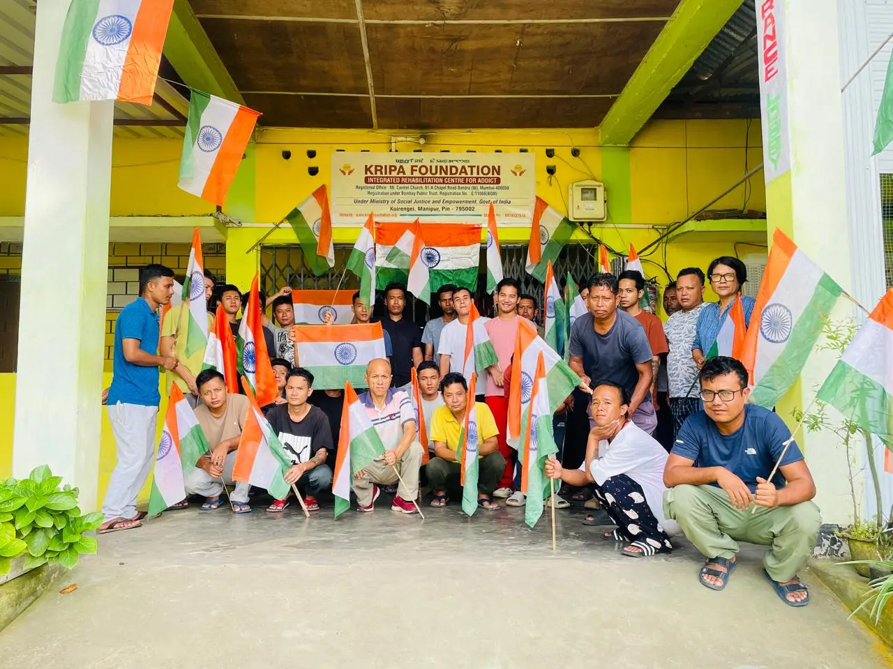 Staff and residents of Kripa Foundation IRCA with the national flag during Har Ghar Tiranga 2026